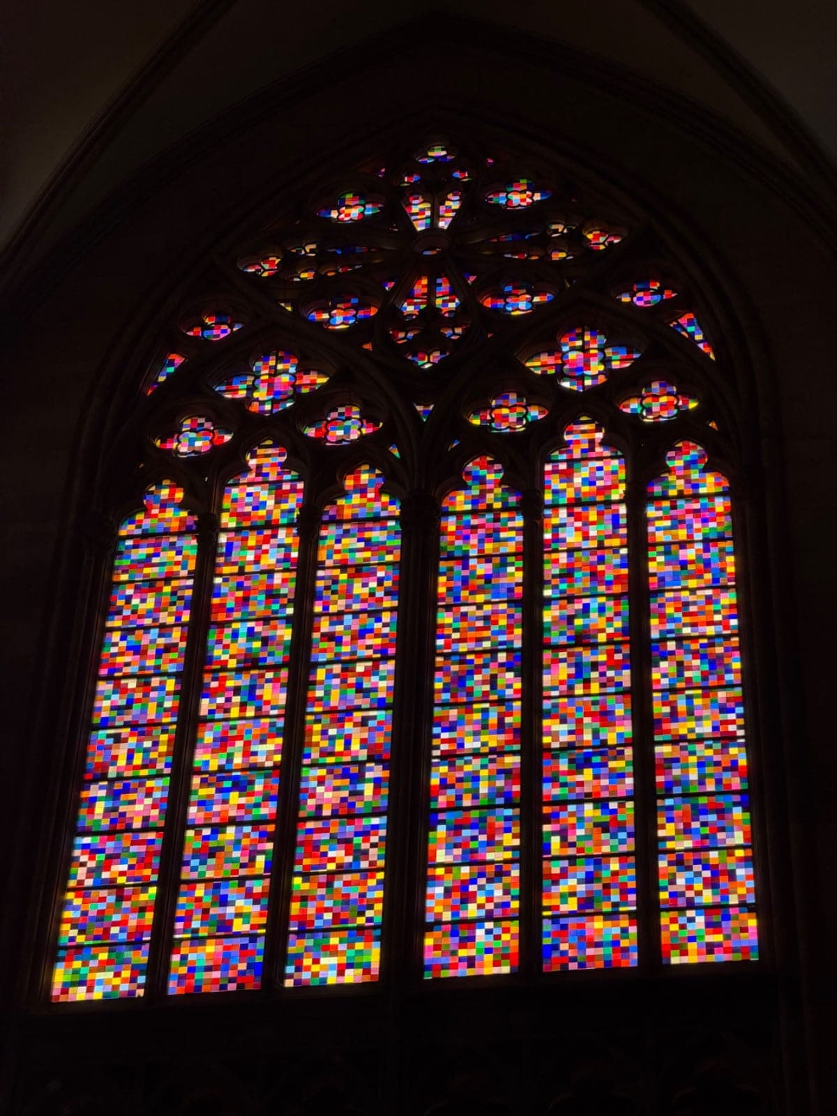 Colorful Gothic church window with pointed tracery in Cologne Cathedral